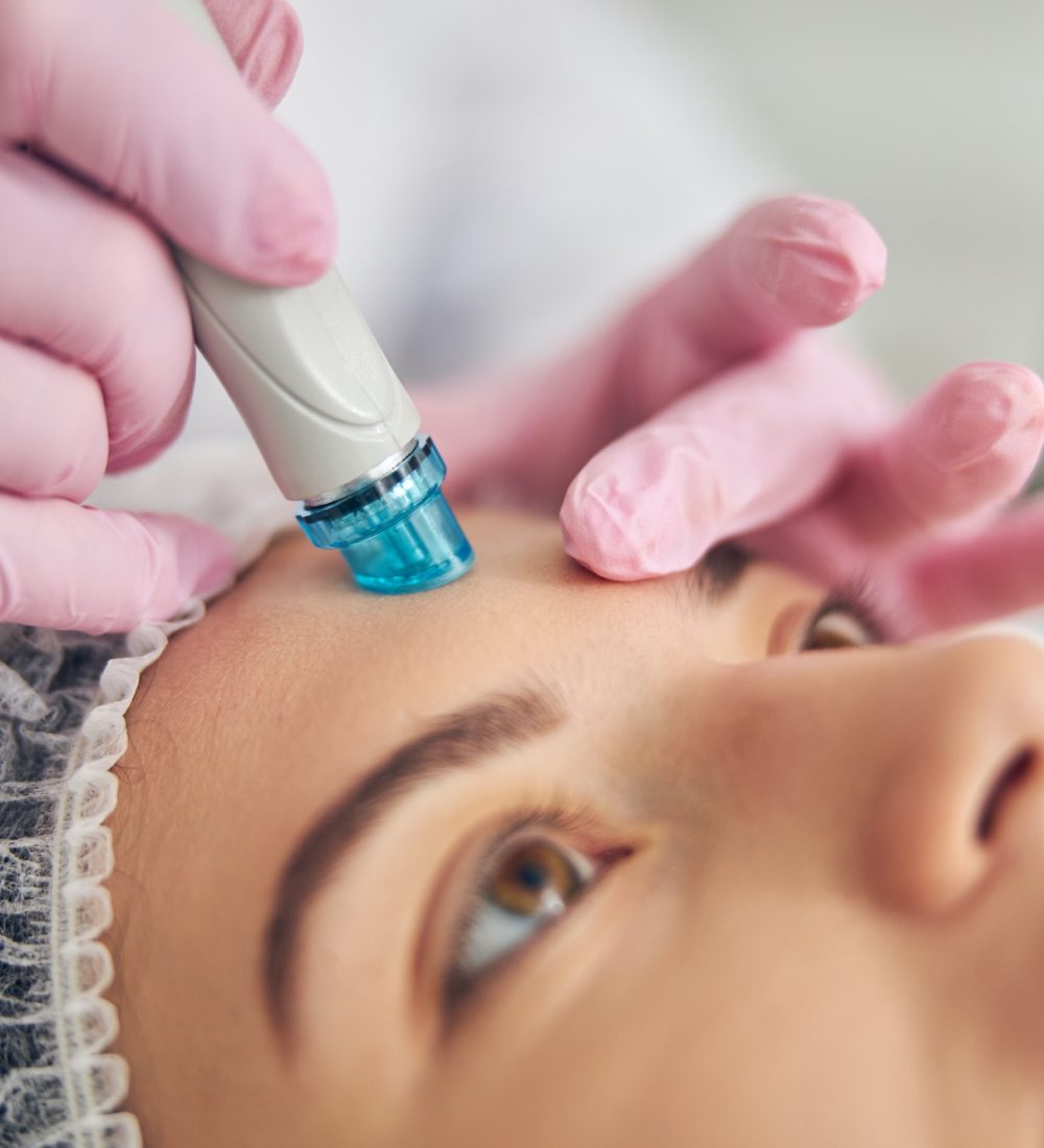 Doctor performing a facial skin cleansing procedure