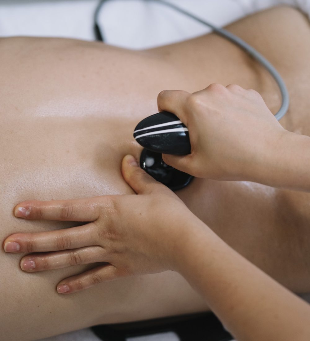 The physiotherapist treating a man using equipment for radio therapy