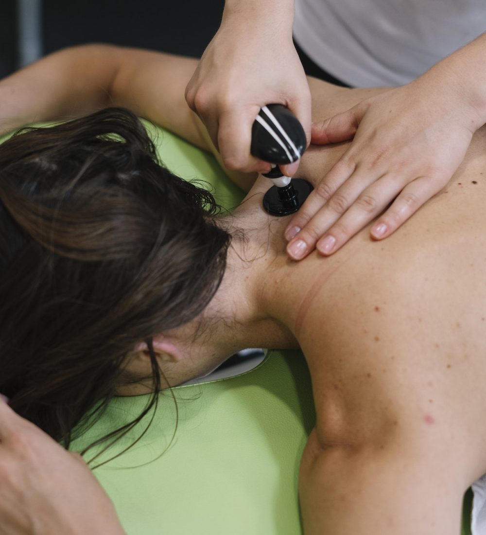 The physiotherapist treating a woman using equipment for radio therapy