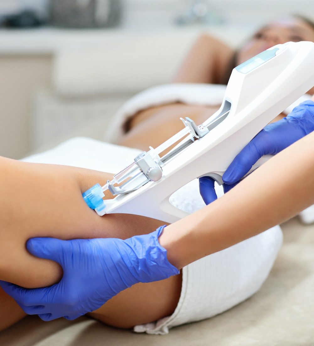 Woman having leg mesotherapy in beauty salon