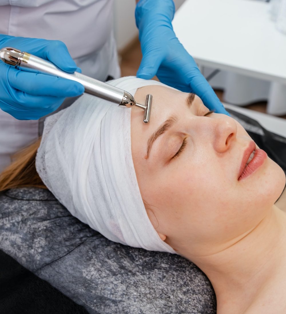 Woman in spa having a facial treatment. Equipment for skincare.