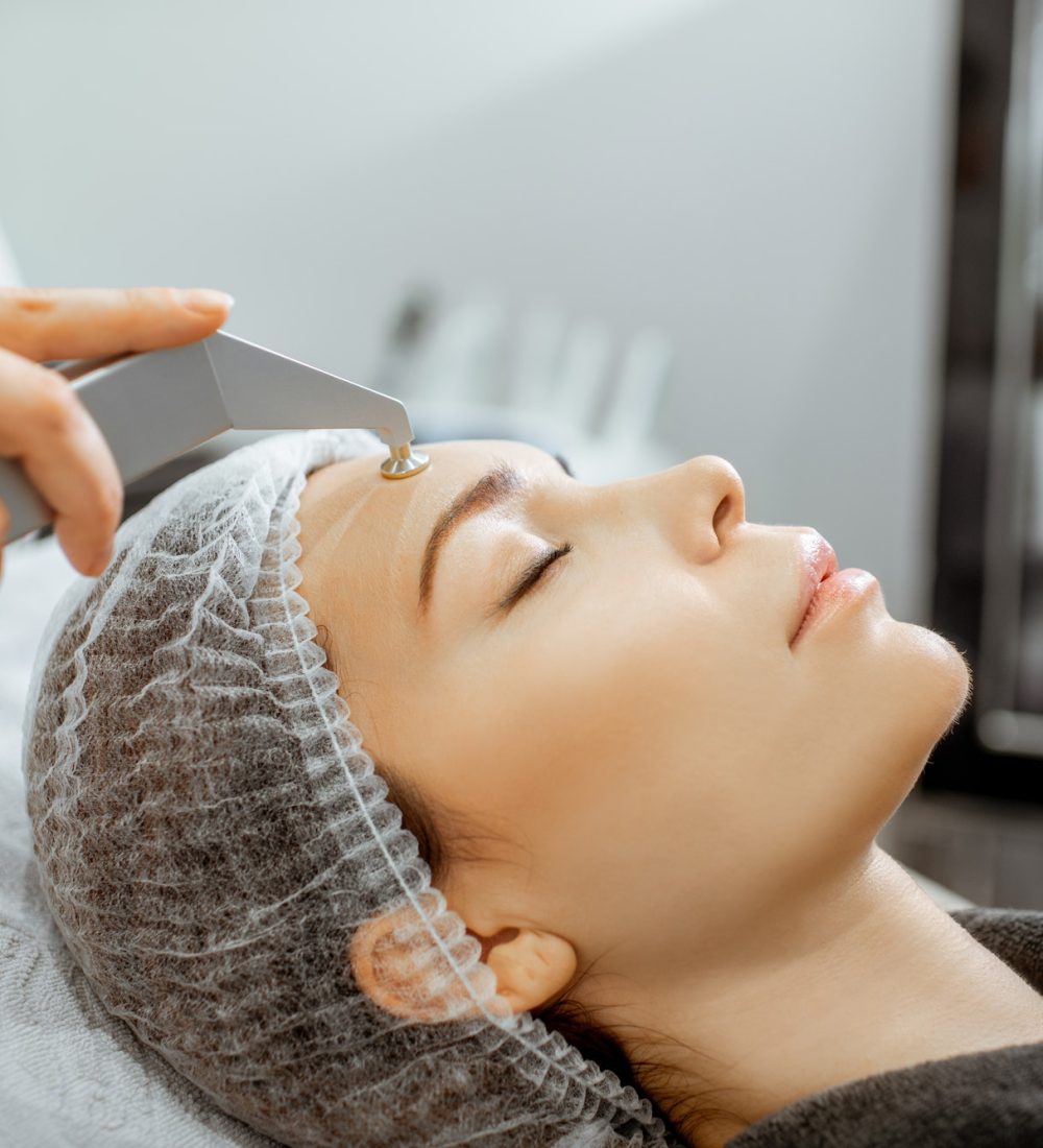 Woman making vacuum hydro peeling at the beauty salon