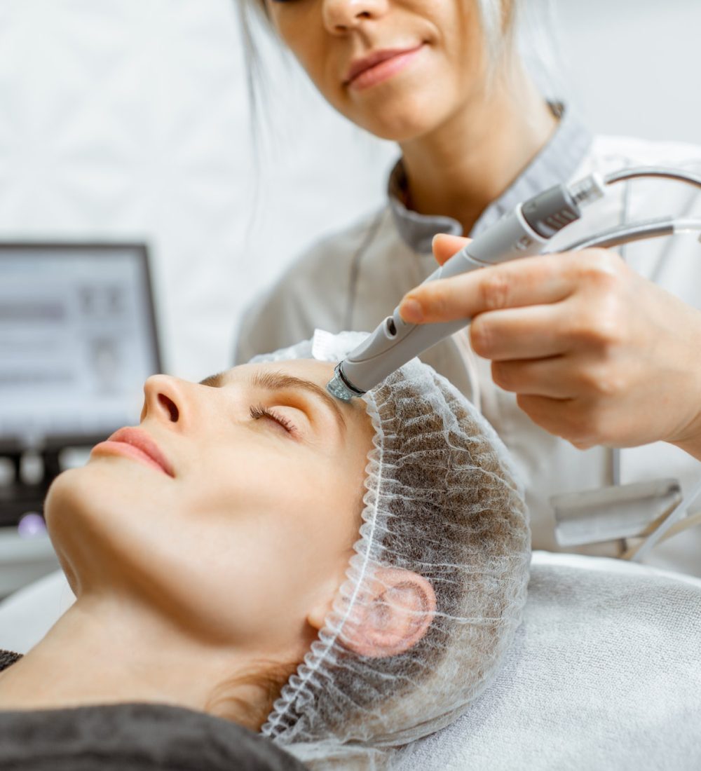 Woman making vacuum hydro peeling at the beauty salon