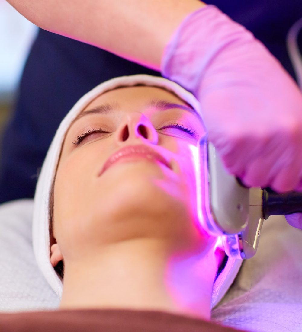 young woman having face microdermabrasion at spa